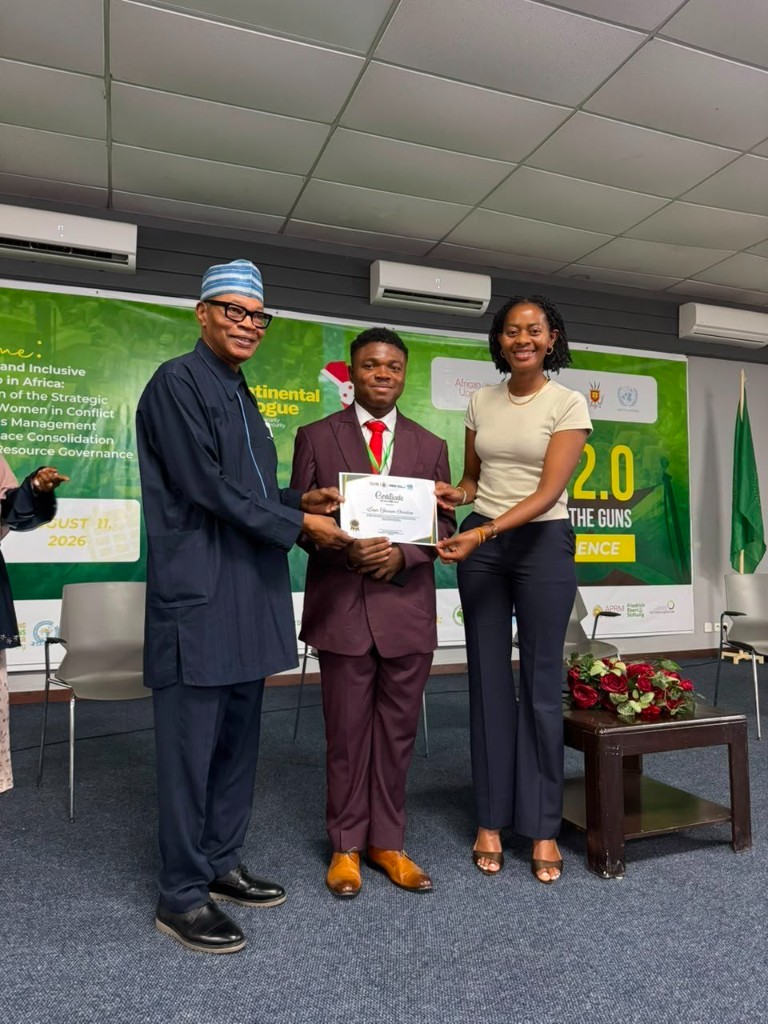 Samson Christian receiving a certificate